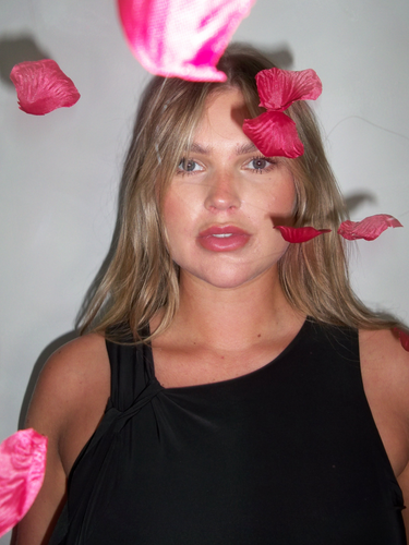 Two women wear the Brushed Cotton Pyjamas whilst sitting together on a window sill.