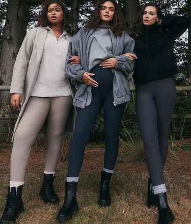 Three models wearing Everyday Winter Leggings and Extreme Fleece Lined Leggings from LOVALL. They are outside, in the woods and wrapped up in layers of warm clothing.